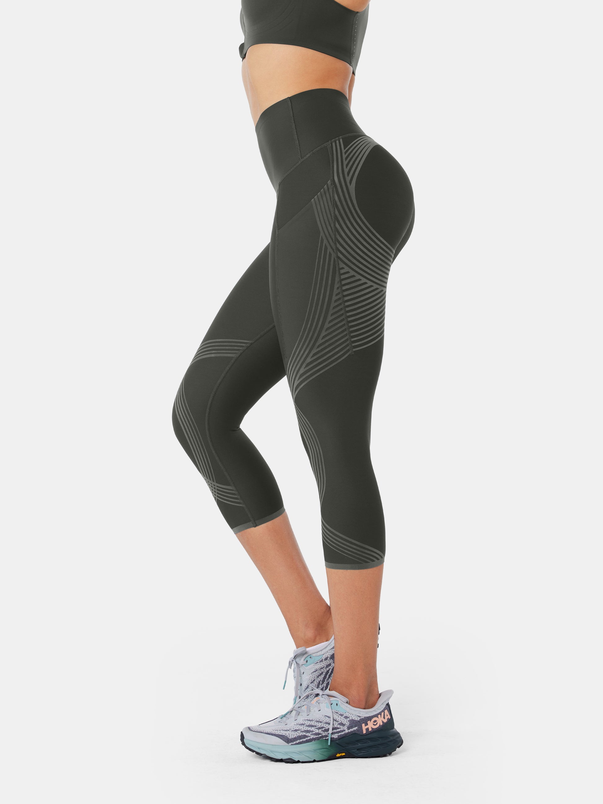 Women's charcoal grey active high rise capri leggings workout leggings. -  Flattening elasticized waistband with interior pocket and back zipper  pocket - Figure sculpting skinny leg design - Exterior side pocket along